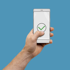 Male hand holding modern smartphone with green checkmark icon on screen