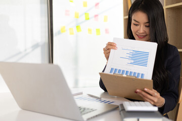 Business woman in the office working on the audit of business reports and auditing documents.