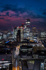 Fototapeta premium Elevated view of the illuminated Liverpool Street and the City of London during night time