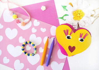 Child preparing  for Mothers Day, making greeting card. Girl making paper sun and fabric flower as gifts for Mothers day, Birthday or Valentines day . Arts  crafts concept.