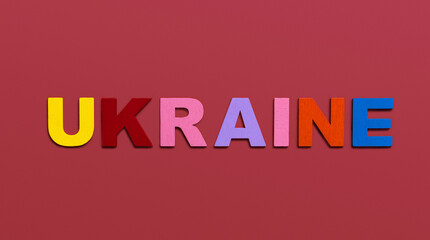 Ukraine, word written in colorful wooden alphabet letters on red background. The concept of a terrible war