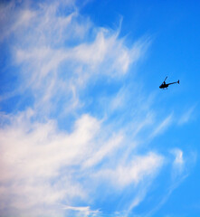 Military Helicopter against cloudy sky. Military scene
