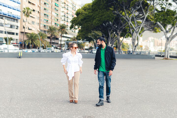 Man and woman talking and walking down the street