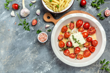 cooking viral Feta bake pasta with roasted cherry tomatoes, cheese, herbs and garlic. menu recipe place for text, top view