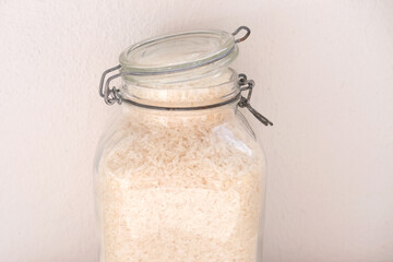 raw white rice in glass jars with sealed lids, the concept of food strategic stocks for a rainy day, food supplies for cooking, ecological packaging, pest control