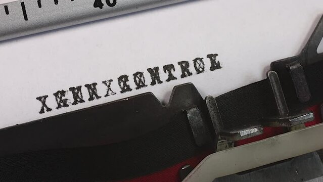 Blocking out or stopping Gun Control on an old manual typewriter. Censorship of sensitive control measures. Obscuring or redacting gun control. Freedom from the control of guns.