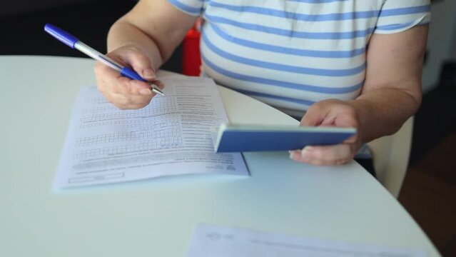 PESEL. National identification number in Poland. Polish ID. Official personal document.Woman hand write with a pen in PESEL document on white table