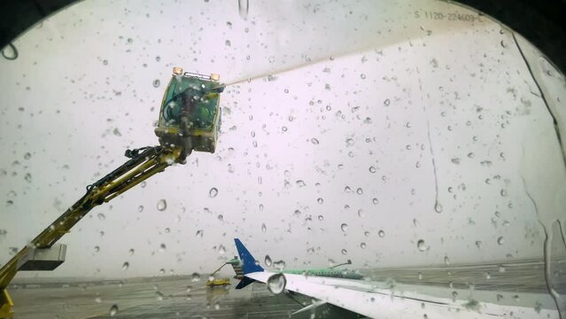 Window Seat POV From Airplane Window With De-Icing Fluid Being Sprayed Overhead