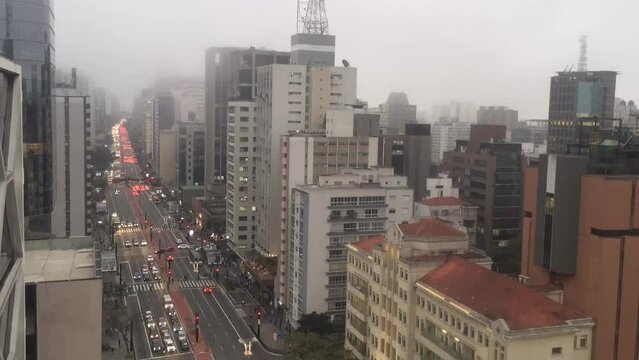 Aerial time lapse of the Paulista avenue traffic jam with fog passing by.