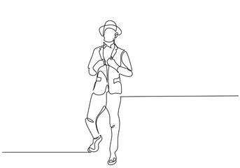 stylishly dressed gentleman businessman model male in a suit hat posing