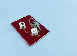 Passport, keys, cubes with the image of the planet and the house. Migration concept