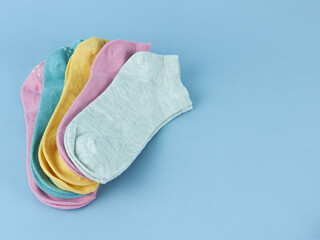 multicolored socks close-up on a blue background