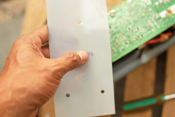 Closeup of a man doing UPS machine troubleshooting and repair. Electronics technician