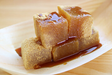 Closeup of Mouthwatering Warabimochi with Kuromitsu Syrup, a Japanese Traditional Confection