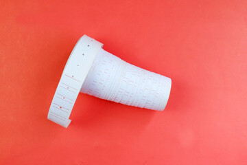 Price tag paper roll, paper sticker isolated on red background