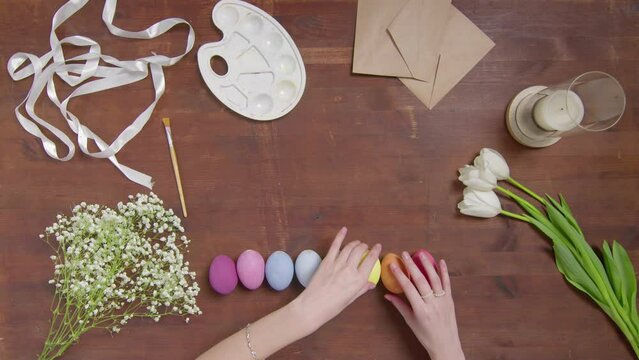 Top view of a table with items to create a composition for Easter. Women's hands arrange objects on the table. Church holiday-Easter