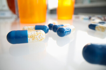 Medical pills capsules with granules on table closeup