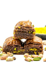 Chocolate baklava with pistachio on a white background. Traditional Mediterranean cuisine delicacies. Close-up Chocolate Baklava. local name cikolatali baklava