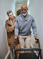 Love is the only special need he has. Shot of a senior woman helping her husband to walk with his walker. - obrazy, fototapety, plakaty