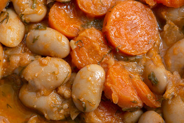 Baked giant beans with parsley,  chopped carrots and tomato sauce. Greek traditional food