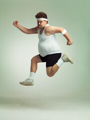 I feel in shape already. Overweight man leaping in the air with his sense of achievement.