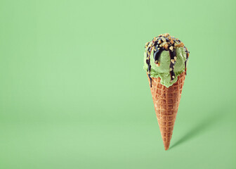 Pistachio ice cream scoop in waffle cone