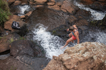 Girl walking through a waterfall