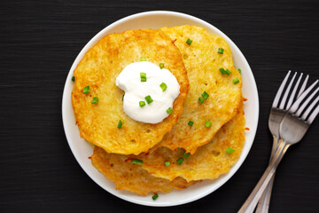 Homemade Boxty Irish Potato Pancakes on a Plate on a black background, top view. Flat lay, overhead, from above.
