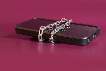 Nomophobia. The smartphone is rewound by a chain 