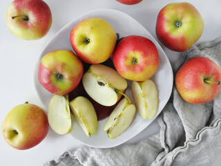 Bright apples and apple slices on a plate