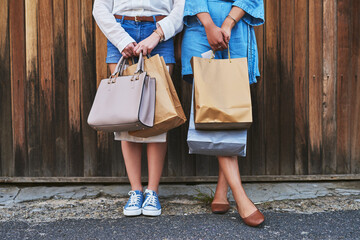 We just thought we deserved to hold these bags today. Cropped shot of two unrecognizable...