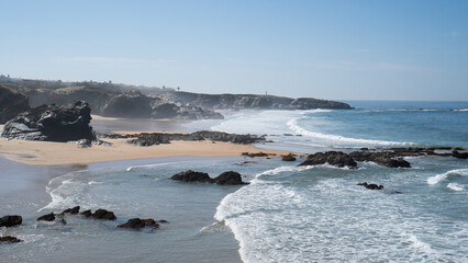 Fototapeta na wymiar Praia Grande de Porto Covo. Atlantic ocean beach on the rock coast. Cliff and sand beach. Alentejo, Portugal