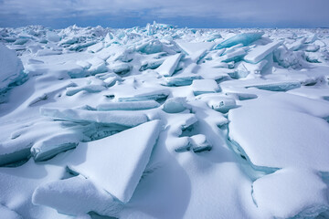 Winter landscape of blue ice shards and snow covered shoreline of Lake Michigan, Empire Beach,...