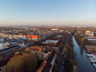 Drone aerial view of Hamburg during sunrise.
The skyline of Hamburg over the buildings and canals can be seen on a sunrise time.