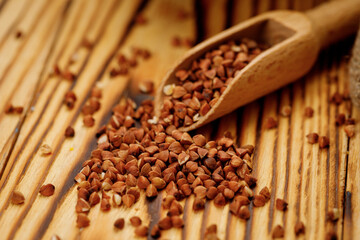 Buckwheat groats in bowls and bags on a wooden background. High quality photo