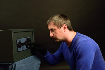 The thief breaks the safe with a combination lock