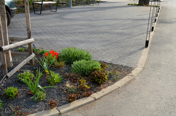 new established street in the city, the longitudinal parking lot is made of gray concrete...