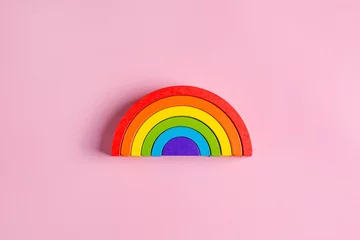 Foto op Canvas Colorful Waldorf wooden rainbow in a montessori teaching pedagogy on pink background, kid play concept © KatrinaEra
