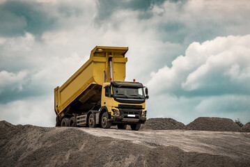 Construction site, yellow truck with raised body