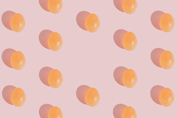 Glossy egg pattern on gentle pink background. Minimal Easter concept. Flat lay aesthetic with copy space.