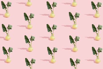 Kohlrabi pattern on pink pastel background. Health and vegan concept. Minimal Easter idea. Raw vegetable aesthetic.