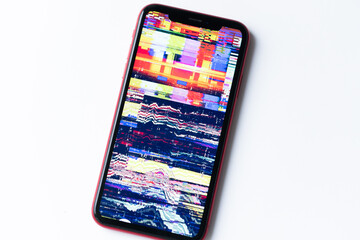 smartphone, mobile phone closeup. Glitches, distorted, corrupted image with colorful lines on the...