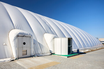 Inflatable air dome stadium. Inflated Tennis air dome or Tennis bubble arena entrance door into...
