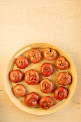 Top view of garden organic tomatoes on a round tray. Purple calabash tomato heirloom variety.