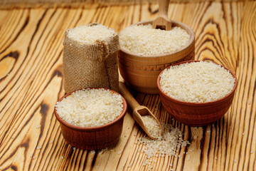 Polished round rice in bowls and bags on a wooden background. High quality photo