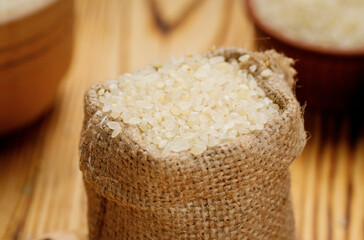 Polished round rice in bowls and bags on a wooden background. High quality photo