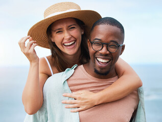 Time flies when youre in love. Shot of a happy young couple enjoying a piggyback ride on a vacation along the coast.