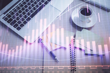 Stock market graph and top view computer on the table background. Double exposure. Concept of financial education.