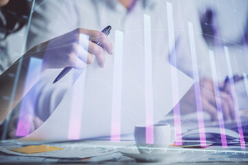 Double exposure of forex graph drawing over people taking notes background. Concept of financial analysis