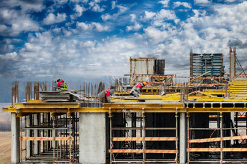 Monolithic frame construction of the building. Workers working at the construction site at home. The framework for the walls. Formwork for walls made of concrete. construction site close up.